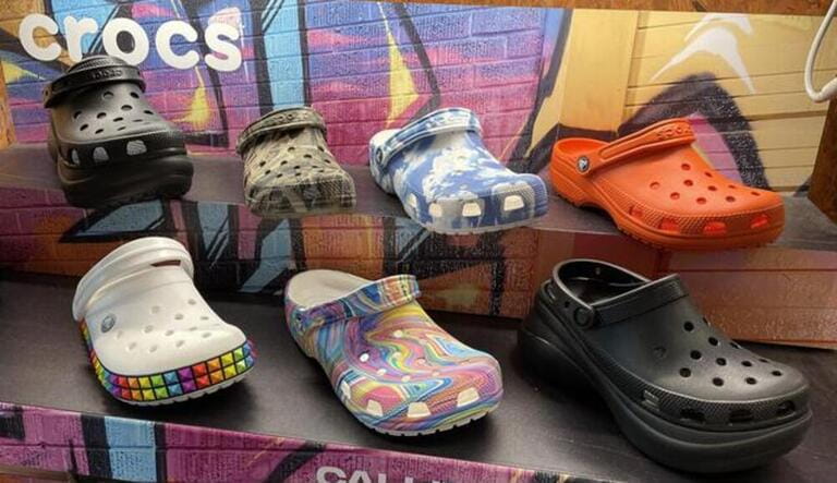 A scenic shot of a store shelf with New Women's Croc Shoes with fun patterns in Fresno