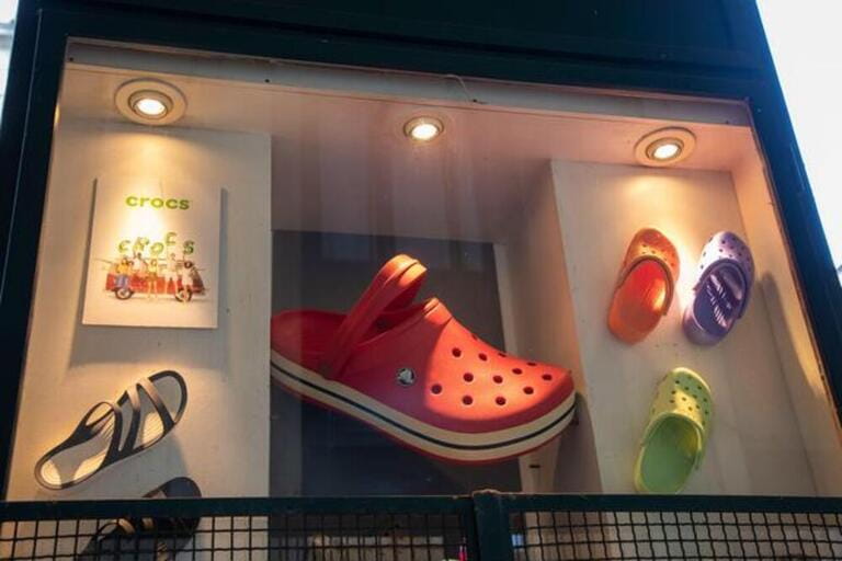 crocs text sign and logo brand front facade boutique chain American footwear company store manufactured foam clog plastic shoes shop
