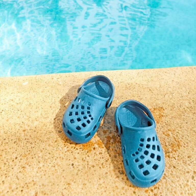 Blue sandals next to the pool Blue sandals next to the pool