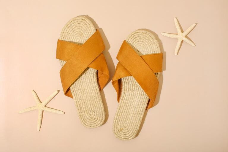 Starfish sea and sandals on beach beige background. Summer background. Decorative textile . Isolated object.