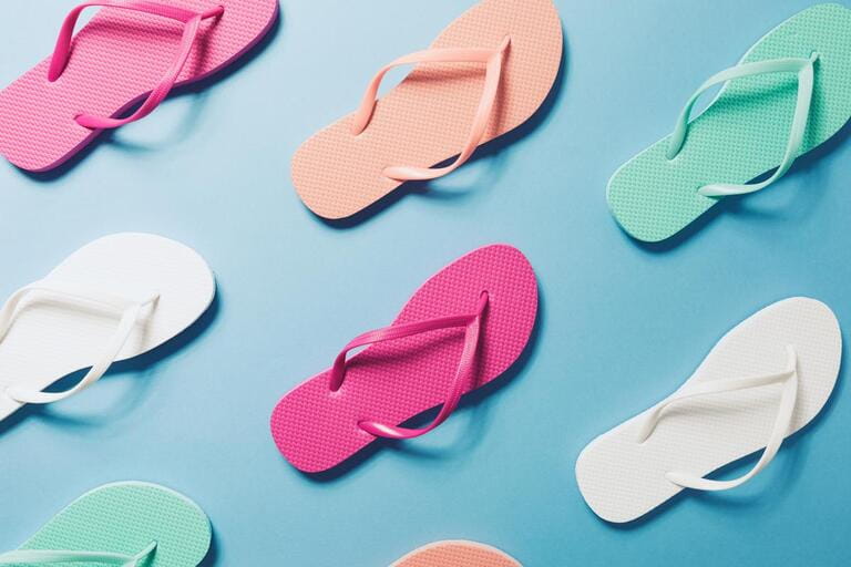 Overhead view of flip flops on the blue background. Horizontal Overhead view of flip flops on the blue background. Horizontal