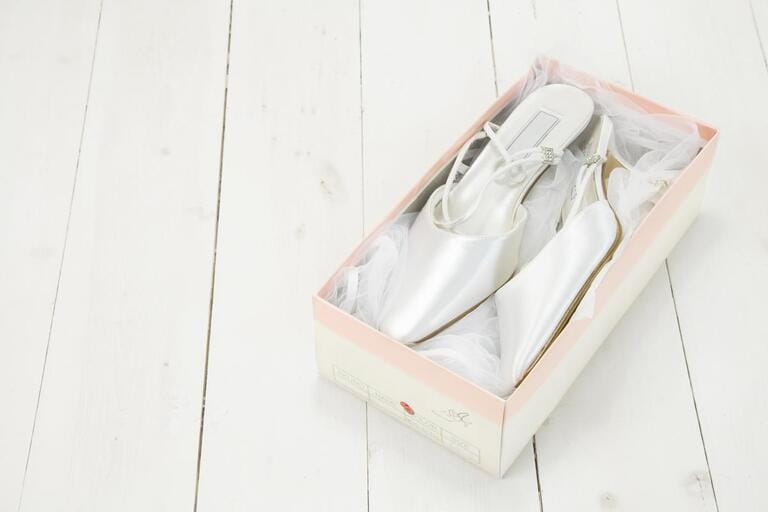 close up of brides white Wedding closed toe shoes in a box