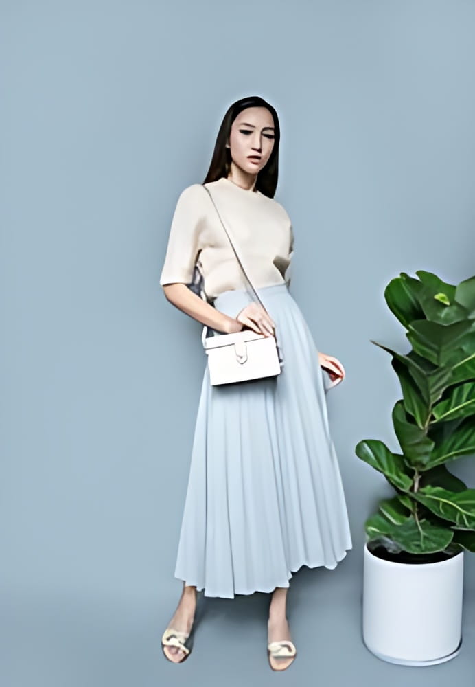 fashion asian girl wears knit long sleeve tops and blue long skirt with white leather handbag and silver sandals